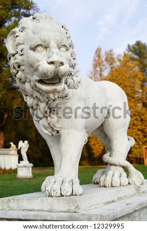 Old lion statue in l autumn park