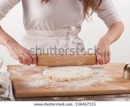 Young woman with lovely hands making home-made buttermilk biscuits using fresh ingredients