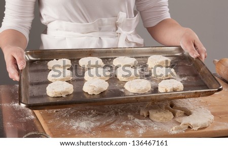 Young woman with lovely hands making home-made buttermilk biscuits using fresh ingredients