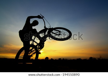 silhouette of the cyclist riding a road bike at sunset at Thailand