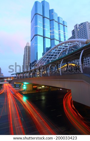BANGKOK - JUNE 21 : Buildings and a sky walk architecture like spider for transit between Sky Transit and Bus Rapid Transit Systems Sathorn-Narathiwas junction on June 21, 2014 in Bangkok, Thailand.