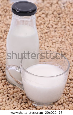 Soy beans and soy milk in a glass cup.