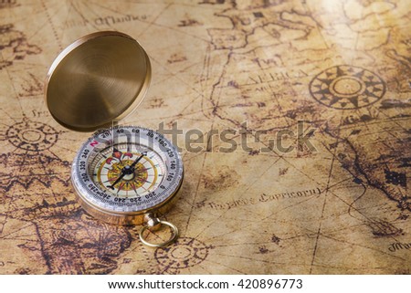Old compass on map.