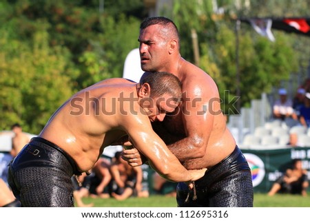 ISTANBUL - AUGUST 24: Unidentified wrestlers in the Sile Annual Oil Wrestling Event on August 24, 2012 in Istanbul. Pehlivan aims to control his opponent by putting his arm through the latter\'s kisbet