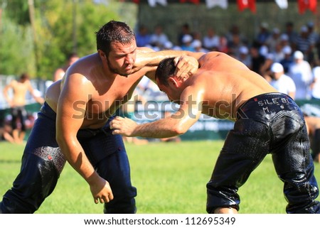 ISTANBUL - AUGUST 24: Unidentified wrestlers in the 8th Sile Annual Oil Wrestling Event on August 24, 2012 in Istanbul. Wrestlers trying to hand-back of opponents neck