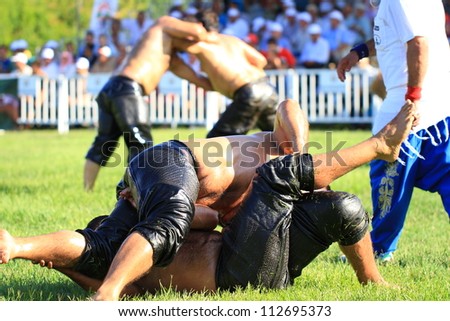 ISTANBUL - AUGUST 24: Unidentified wrestlers in the 8th Sile Annual Oil Wrestling Event on August 24, 2012 in Istanbul. Wrestler touches the ground