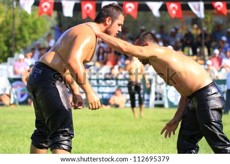 ISTANBUL - AUGUST 24: Unidentified wrestlers in the 8th Sile Annual Oil Wrestling Event on August 24, 2012 in Istanbul. Wrestlers trying to grab each other