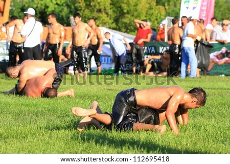 ISTANBUL - AUGUST 24: Unidentified wrestlers in the 8th Sile Annual Oil Wrestling Event on August 24, 2012 in Istanbul. Oil wrestling also called grease wrestling is a Turkish national sport.