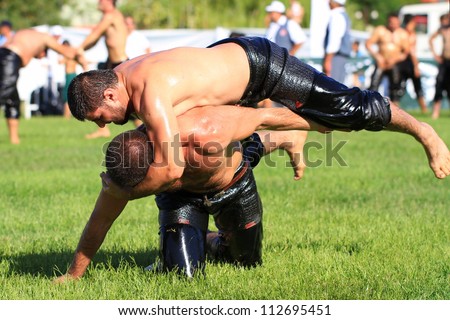 ISTANBUL - AUGUST 24: Unidentified wrestlers in the 8th Sile Annual Oil Wrestling Event on August 24, 2012 in Istanbul. Wrestler fighting an opponent
