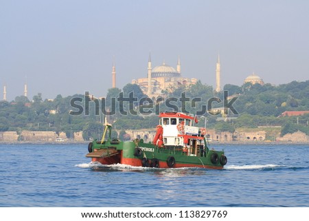ISTANBUL - JUNE 11: Water surface cleaning boat sails into Bosporus Sea on June 11, 2012 in Istanbul. Debris and bilge water collected by Istanbul municipality workers reaches about 30.000 tons/year.