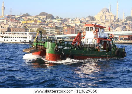 ISTANBUL - SEP 24: Water surface cleaning boat sails into Bosporus Sea on Sep 24, 2012 in Istanbul. Debris and bilge water collected by Istanbul municipality workers reaches about 30.000 tons/year.