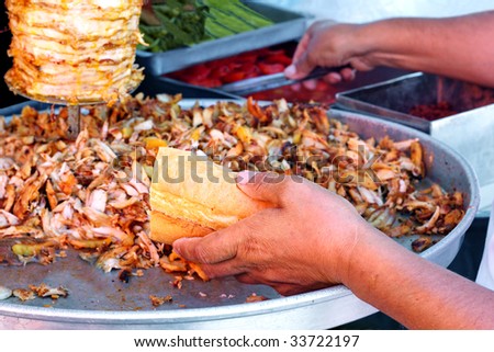 Chef filling up the bread with doner kebab
