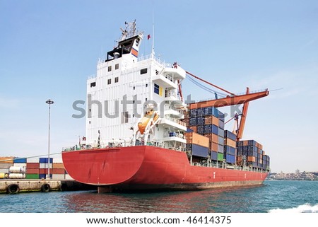 Red container ship at harbor