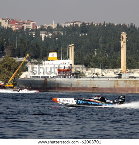ISTANBUL - SEPTEMBER 25: Racing boats speeds along the water at World Offshore Championship, September 25, 2010 in Istanbul. Philippe BENHAMOU, Max DESSAUX run for the Olympique de Marseille team