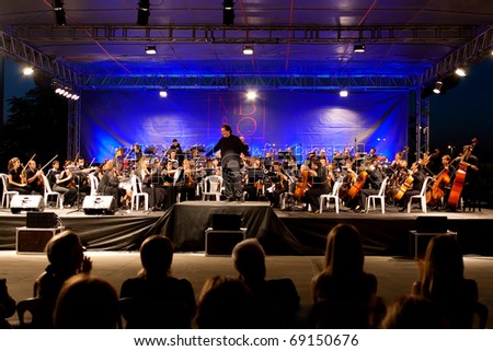 ISTANBUL - JULY 11: Members of the Maltepe Symphonic Orchestra perform live at Maltepe open air stage on July 11, 2010 in Istanbul