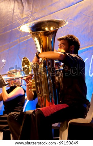 ISTANBUL - JULY 11: Members of the Maltepe Symphonic Orchestra perform live at Maltepe open air stage on July 11, 2010 in Istanbul, Tuba player blows
