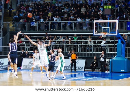 ISTANBUL - JANUARY 20: Kerem Gonlum (12) takes a three point shot at THY Euroleage Top 16 Championship basketball game, Efes Pilsen vs Montepaschi Siena January 20, 2011 in Istanbul, Turkey