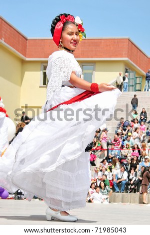ISTANBUL - APRIL 23: An unidentified 12 years old Mexican girl in traditional costume perform folk dance on \