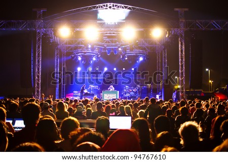 ISTANBUL - SEPTEMBER 18: Pop star Ajda Pekkan performs live during a concert at Maltepe on September 18, 2011 in Istanbul, Turkey. Concert stage and excited spectators are pictured.