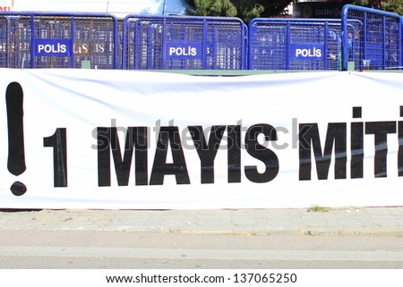 ISTANBUL - MAY 1: Many people can\'t take part in May Day march on May 1, 2013 in Istanbul. Police blocked all the ways to Taksim Square to prevent activists from joining their mates. May Day banner