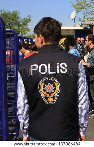 ISTANBUL - MAY 1: Many people can\'t take part in May Day march on May 1, 2013 in Istanbul. Police blocked all the ways to Taksim Square to prevent the activists from joining their mates. Policeman