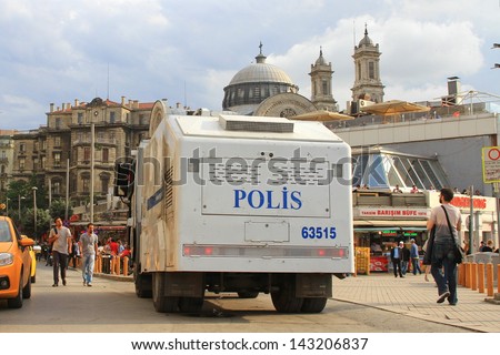 ISTANBUL - JUN 12: Plans to build on Gezipark led to anti government unrest on June 12, 2013 in Istanbul, Turkey. The police wait in their vehicles at the square whilst the protesters occupy the park.