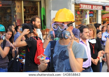 ISTANBUL - JUN 17: Five labor unions call 1-day nationwide strike on Monday over crackdown on June 17, 2013 in Istanbul, Turkey. A demonstrator wearing gas-mask and glasses to protect from pepper gas.
