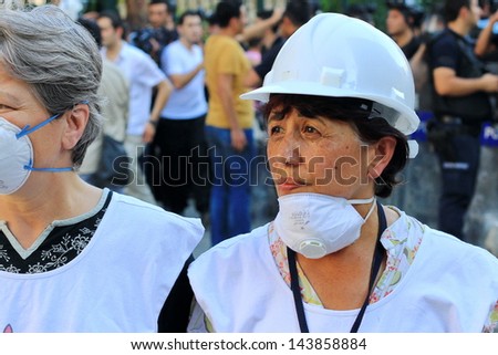 ISTANBUL - JUN 17: Labor unions call 1-day nationwide strike over crackdown on June 17, 2013 in Istanbul,Turkey. Human rights members wearing white helmet, monitor possible abuses during demonstration
