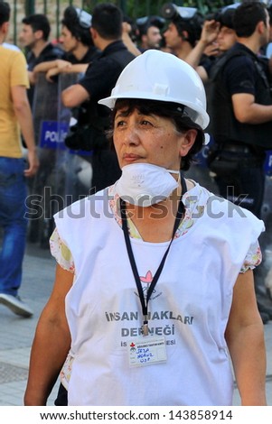 ISTANBUL - JUN 17: Labor unions call nationwide strike over crackdown on June 17, 2013 in Istanbul,Turkey. Human rights member wearing helmet and shirt, monitors possible abuses during demonstration.
