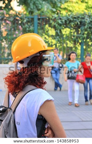 ISTANBUL - JUN 17: Five labor unions call nationwide strike over crackdown on June 17, 2013 in Istanbul, Turkey. A demonstrator wearing glasses to protect from pepper gas at Istiklal St.