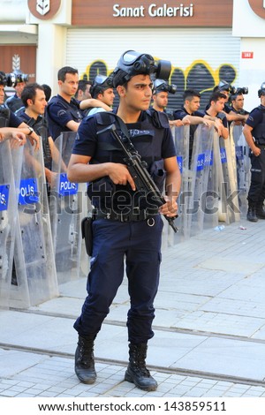 ISTANBUL - JUN 17: Labor unions call 1-day nationwide strike over crackdown on June 17, 2013 in Istanbul. Police wait in full riot gear on Istiklal Street to prevent people march to Taksim Square.