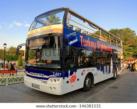 ISTANBUL - JUL 15: Sight seeing tourist bus in front of Hagia Sophia on July 15, 2013 in Istanbul. Sultanahmet Square one of the most popular travel destination in Turkey. Turkey Travel