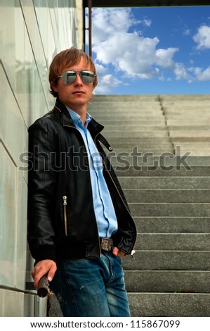 guy standing on the steps in glasses and jacket