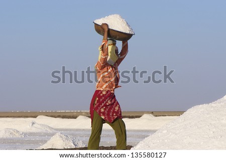 DHRANGADHRA, INDIA - MARCH 13: Unidentified Indian woman salt worker, Little Rann of Kutch. On March 13, 2012 in Dhrangadhra, India.  India is world\'s 3rd largest producer of salt, 80% from Gujarat.