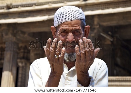 AHMEDABAD, GUJARAT, INDIA - FEB 28: Unidentified man prays at Dada Hari Ni Vav mosque, on February 28, 2012 in Ahmedabad, India. Ahmedabad has a large Muslim population in this mainly Hindu state.