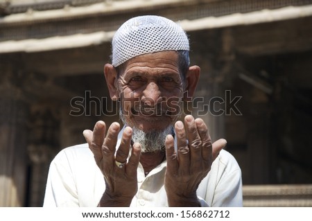 AHMEDABAD, GUJARAT, INDIA - FEB 28: Unidentified man prays at Dada Hari Ni Vav mosque, on February 28, 2012 in Ahmedabad, India. Ahmedabad has a large Muslim population in this mainly Hindu state.