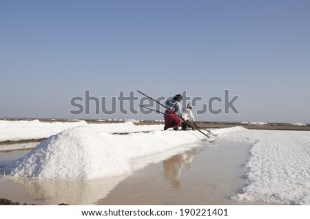 LITTLE RANN OF KUTCH, INDIA: MARCH 13, 2012: Unidentified woman & man salt worker, Little Rann of Kutch, Gujarat, India.  India is the world\'s 3rd largest producer of salt, 80% from Gujarat.