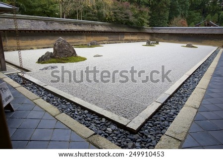 KYOTO, JAPAN - NOV 17: Zen rock garden at Ryoan-ji Temple, on November 17, 2014, in Kyoto, Japan. With 15 rocks placed amongst raked white gravel, it is considered one of the finest dry landscapes.