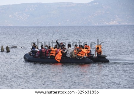 LESVOS, GREECE SEPTEMBER 24, 2015: Refugees arriving in Greece by boat from Turkey. These Syrian refugees land their boat near Molyvos, Lesvos. Turkey can be seen in the background.
