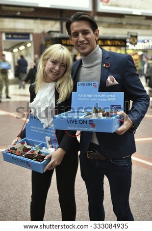 LONDON, UK - OCTOBER 29, 2015: Ollie Locke and Jess Woodley, stars of reality TV show Made In Chelsea, help to raise funds for the Poppy Appeal at Victoria Station, London, UK