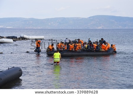 LESVOS, GREECE SEPTEMBER 24, 2015: Refugees arriving in Greece by boat from Turkey. Escaping war and IS (ISIS) these Syrian refugees land their boat on Lesvos. Turkey can be seen in the background.