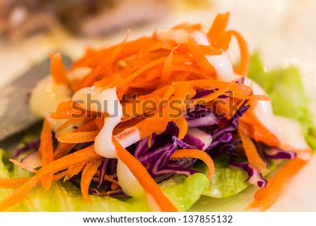 Salad./Carrot salad topped with mayonnaise.