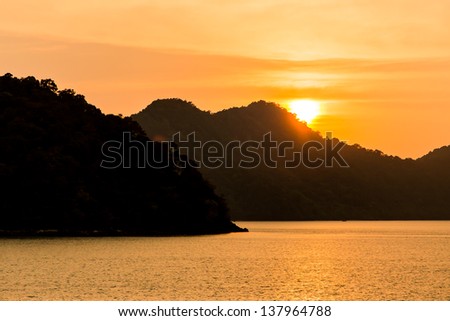 Sea, sun, mountains./Sunset at Sea Island in front.