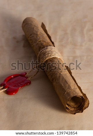 Ancient parchment scroll with wax seal and twine