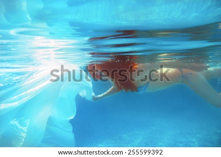 Red-hair girl with white cloth underwater