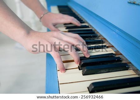 girl playing blue piano