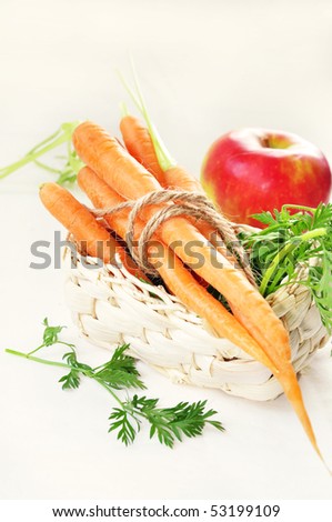 fresh and juicy carrot and apple in a basket