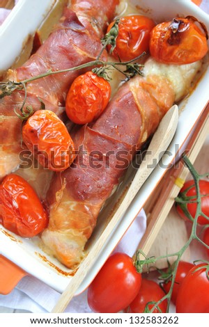 salmon wrapped in prosciutto di parma with gorgonzola cheese and tomatoes