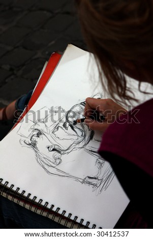 A girl drawing an elephant  in the street