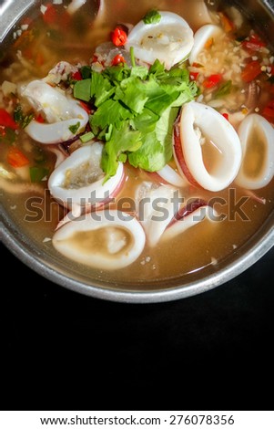 Thai Food,Squid ring in spicy soup with black background